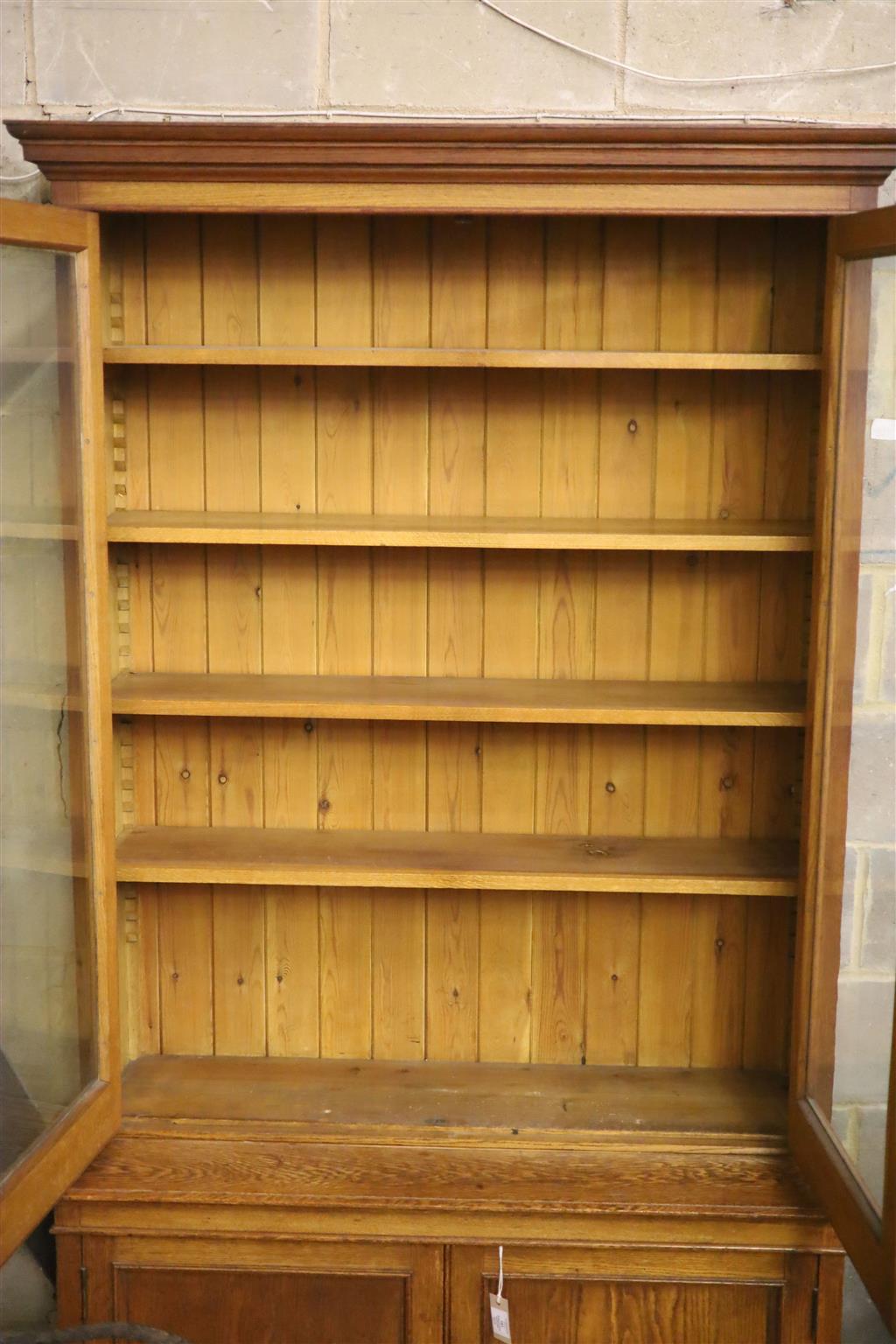 A late 19th century panelled oak library bookcase, length 118cm, depth 47cm, height 223cm